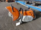 a chainsaw that is sitting on the ground next to a fork