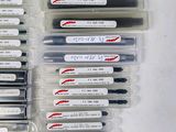 a lot of pens that are in a plastic container