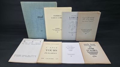 a group of books sitting on top of a table next to each other