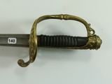 a sword with a handle on a white surface