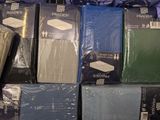 boxes of various colored shirts are stacked on top of each other