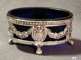 a silver and blue glass bowl on a table
