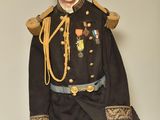 a man in a military uniform sitting on a chair