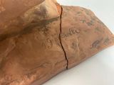 an image of a close up of a piece of copper on a white surface
