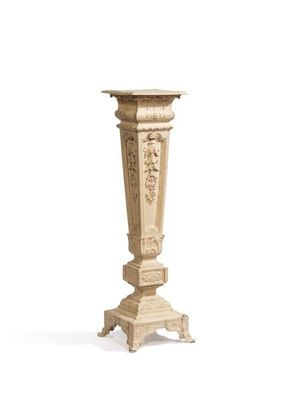 a tall pedestal with a carved design on it