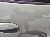 a shadow of a person on the hood of a car