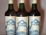 three bottles of wine sitting on top of a table next to each other