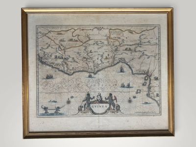 an old map of the world is hanging on a wall in a room