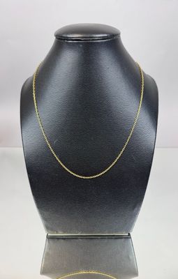 a black mannequin with a gold chain on it