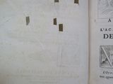 an open book with a cross drawn on it sitting on top of a table