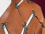 a close up of a mannequin wearing a brown leather jacket