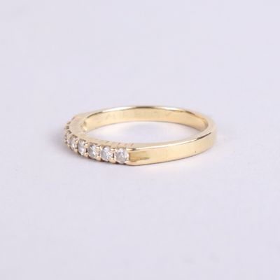 a yellow gold ring with five diamonds on the side