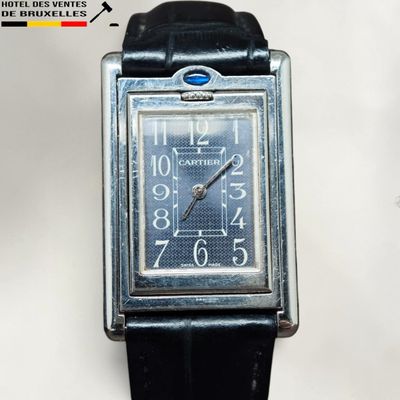 a silver watch with a blue face on a black strap