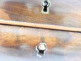 a close up of a wooden dresser with a key on it
