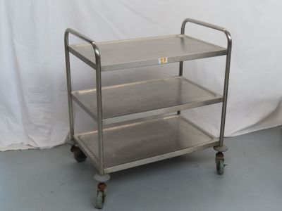 a metal cart that has three shelves on top of it