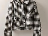 a black and white checkered jacket hanging on a hanger