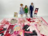 two dolls standing next to each other on a table