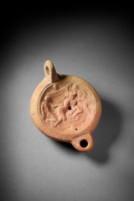 a close up of a clay object with a face on it