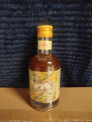 a bottle of liquor sitting on top of a cardboard box