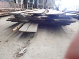 several pieces of wood are stacked on the floor in a warehouse