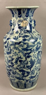a blue and white vase sitting on a table