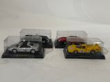 three toy cars in a display case on a white surface