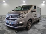 the silver van is parked on a checkered floor in a room