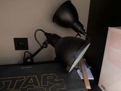 a lamp that is sitting on a desk next to a book