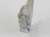 a small statue of a man with a hat on