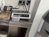a kitchen with a stove and a grill in it