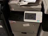 a pile of office printers and a printer on the floor