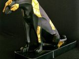 statue of an egyptian cat on a black background