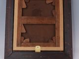 an old wooden picture frame with a picture of a cat in it