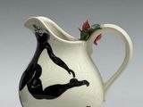 a black and white pitcher with a woman on it