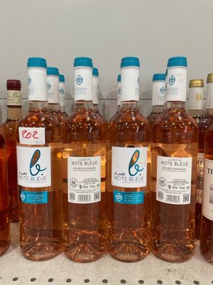 several bottles of wine are lined up on a shelf
