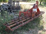 a rusted out plow sitting in the middle of a field