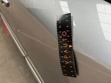a measuring tape on the side of a car door