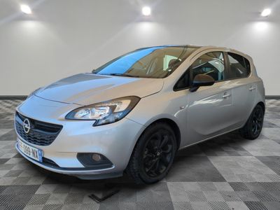 a silver car is parked in a room with a checkered floor