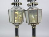 pair of brass and glass street lamps with eagle heads on top