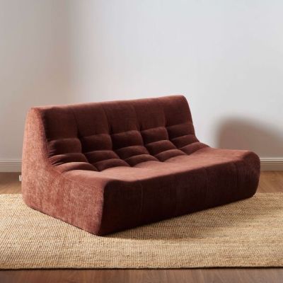an image of a brown couch sitting on top of a rug