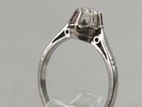 a close up of a ring with a diamond in it