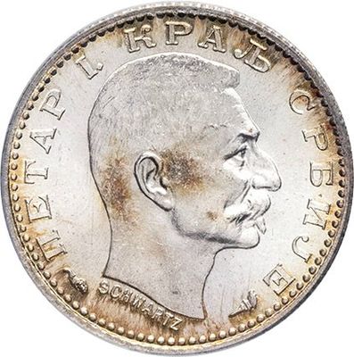 a close up of a coin with a man ' s face on it
