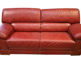 red leather loveseat on a white background