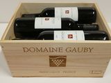 trois bouteilles de vin dans un coffret en bois sur une table