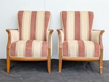 pair of striped upholstered chairs against a white wall