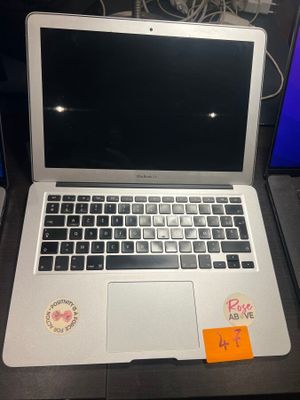 a laptop computer sitting on a desk with a sticker on it