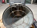 a large metal tube sitting on a pallet in a warehouse