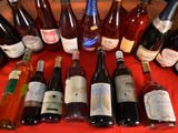 many bottles of wine sitting on a red table