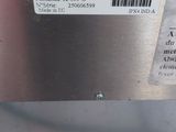 a close up of a metal object with a barcode on it