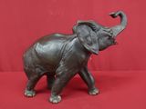 statue of an elephant on a red background with a red backdrop